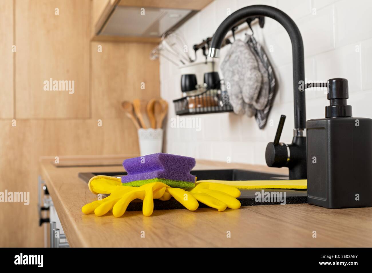 Close up picture of a clean wooden kitchen countertop and black sink ...