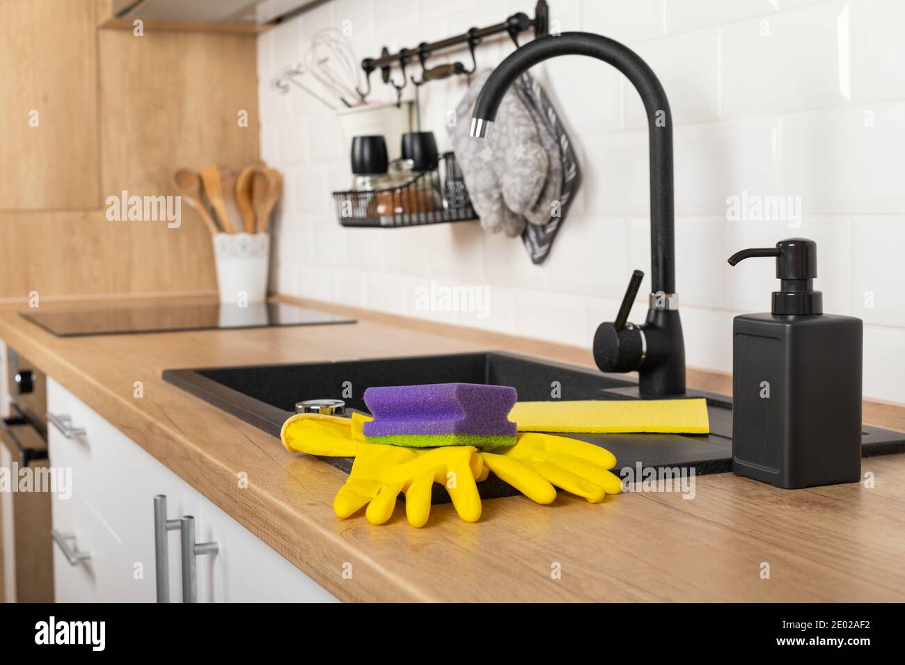 Close up picture of a clean wooden kitchen countertop and black sink ...