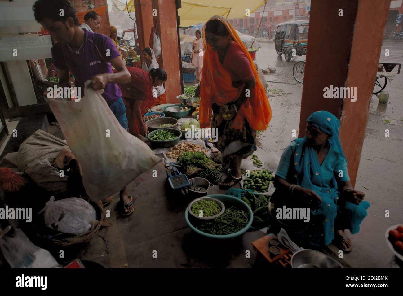 A roadside vegetable market in Jaipur, Rajasthan, India, on a rainy