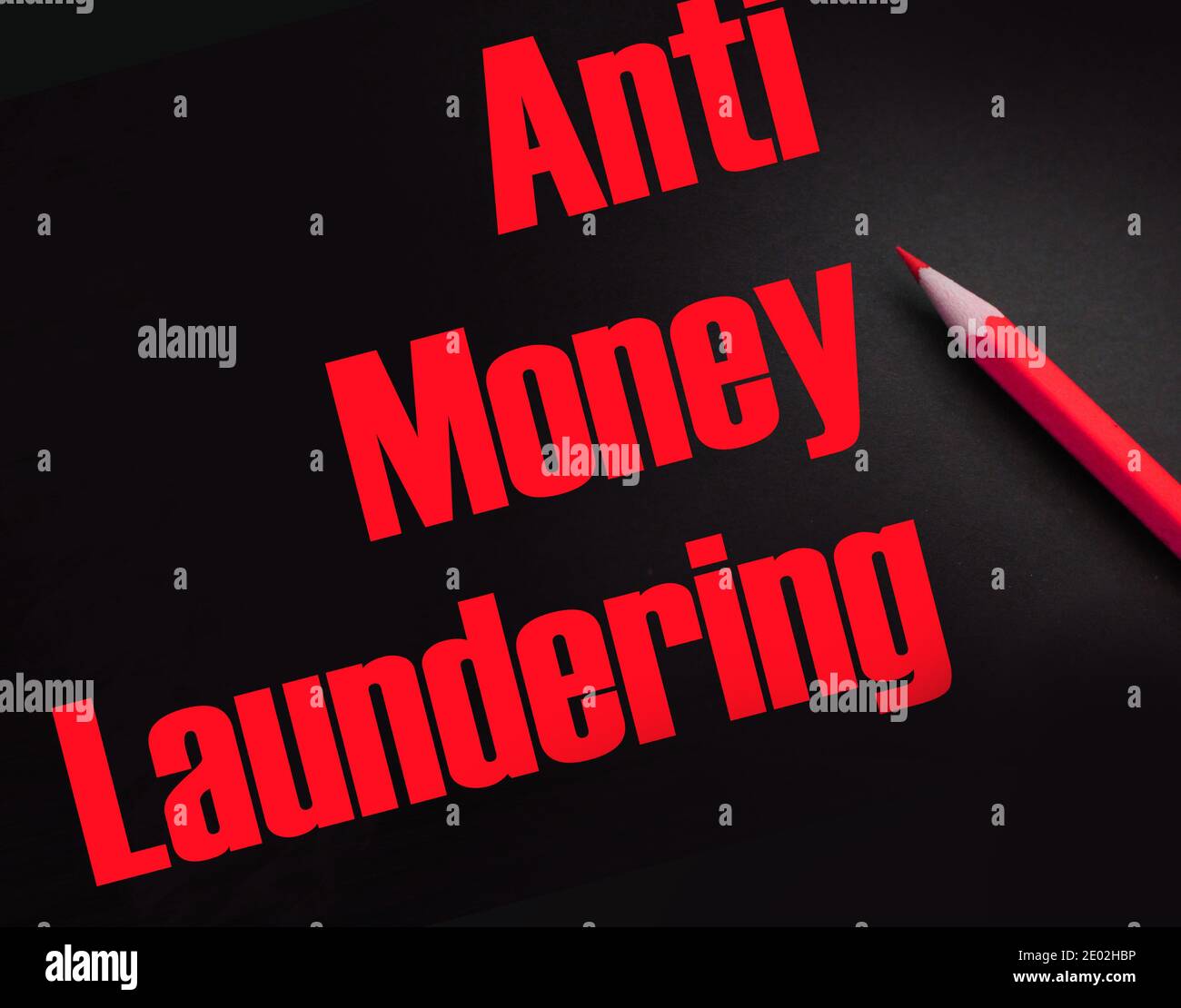 Anti Money Laundering words on black and red pencil besides. AML social ...