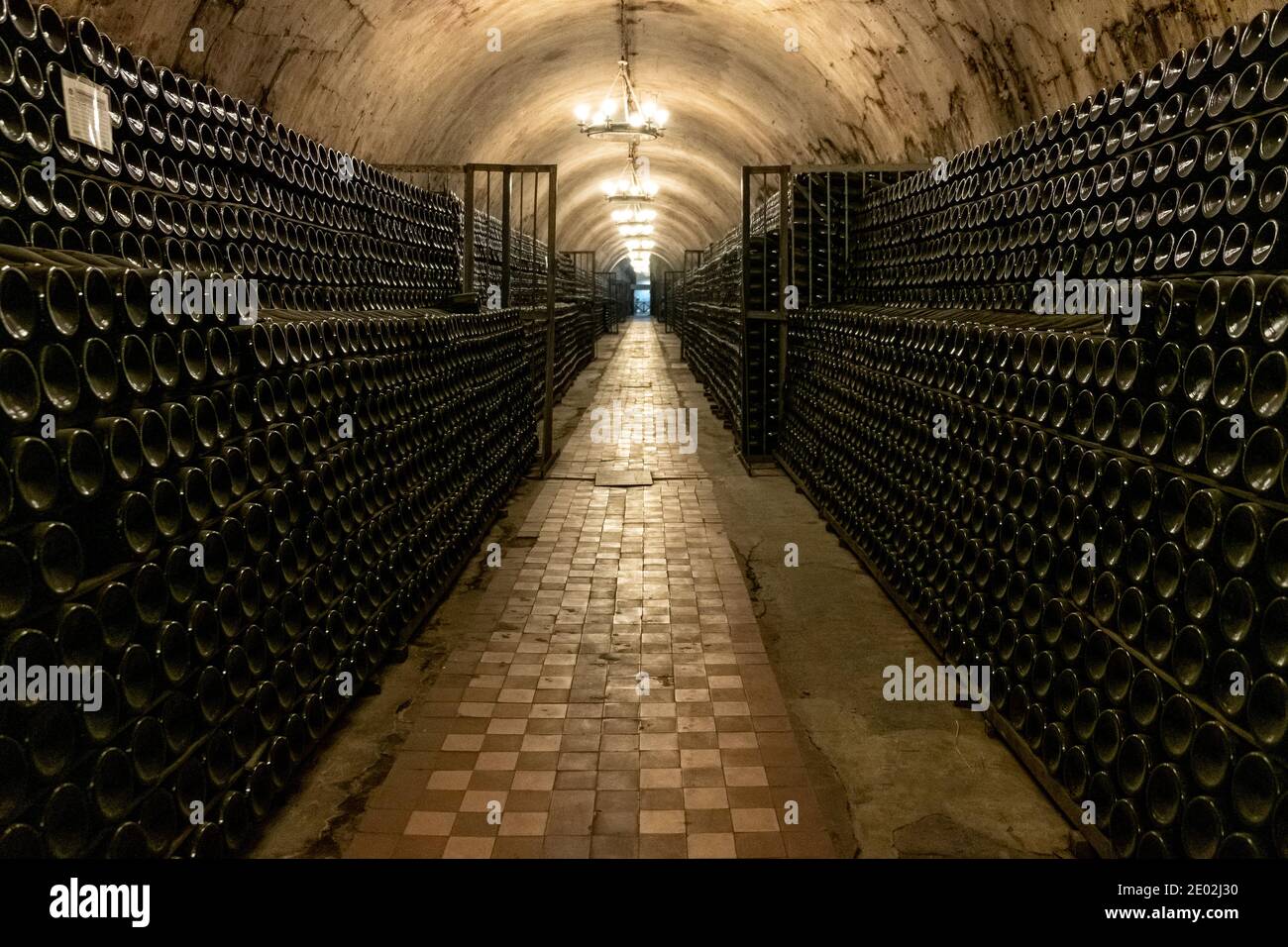 A long antique cellar with lots of aged wine bottles. Sparkling wine production Stock Photo Alamy
