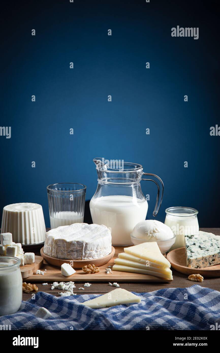 Dairy products on  wood base and blue background with  copy space. Vertical format. Stock Photo