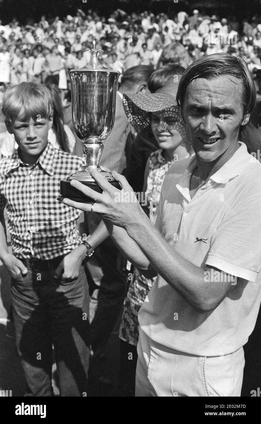 Welsh tennis player Gerald Battrick holding the trophy at the 1971