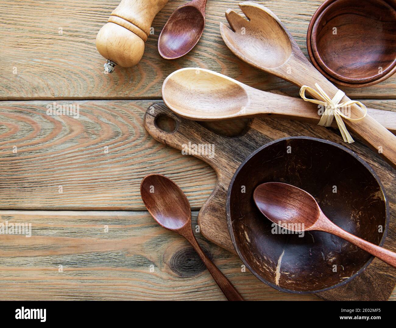 Premium Photo  Kitchen beige apron wooden spoon with spices pepper mill  wood kitchen utensils on a wooden background top view