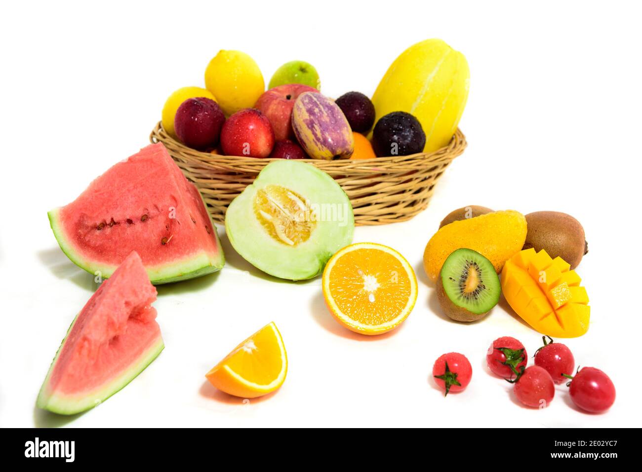 Fresh fruit slices arrangement, ripe juicy fruits in basket, white