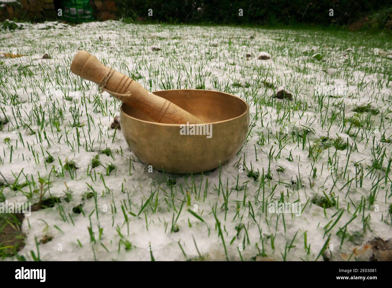 Singing bowl set in a snowy garden Stock Photo