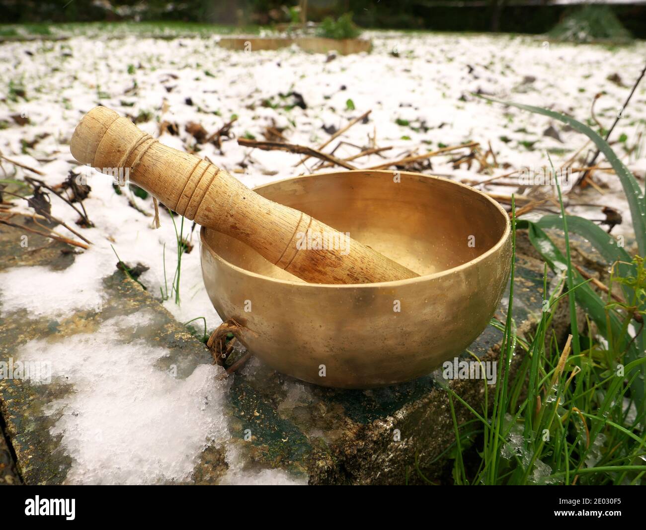 Singing bowl set in a snowy garden Stock Photo