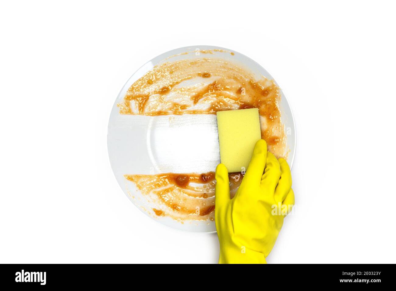 hands in rubber yellow gloves for protection washing dirty plate with ...