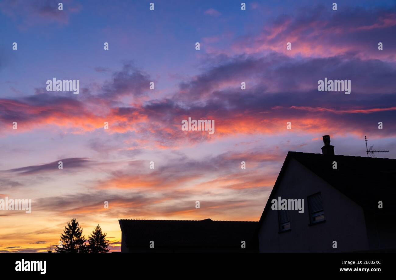 Beautiful sunset over houses against the evening sky; natual view at sunset Stock Photo