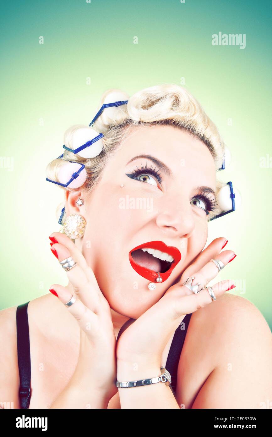 Stereotypical Housewife with hair curlers and surprised expression. Stock Photo