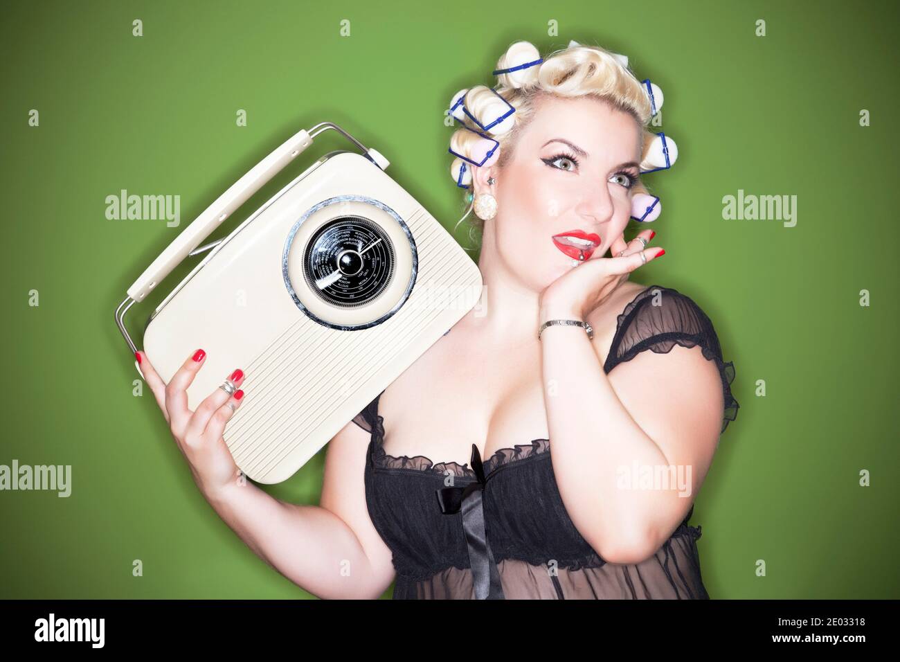 Portrait of a vintage styled housewife with old Radio Stock Photo