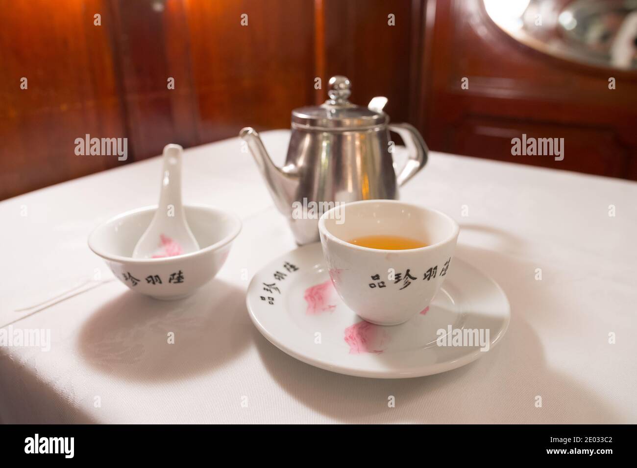 https://c8.alamy.com/comp/2E033C2/tea-service-on-a-white-table-iron-kettle-tea-cup-with-hot-tea-a-soup-bowl-special-spoon-beautiful-typical-chinese-restaurant-2E033C2.jpg
