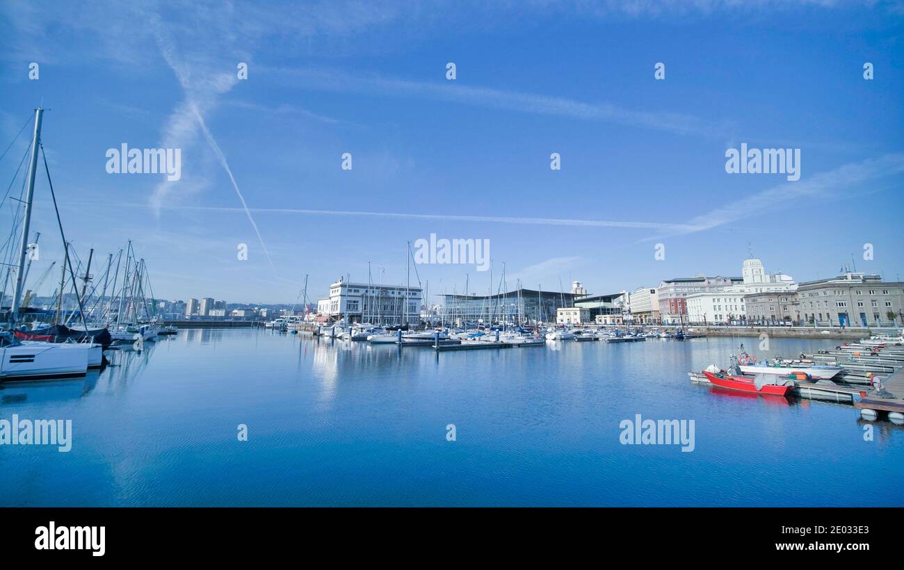 Yachts docking at port; blue seashore Stock Photo Alamy