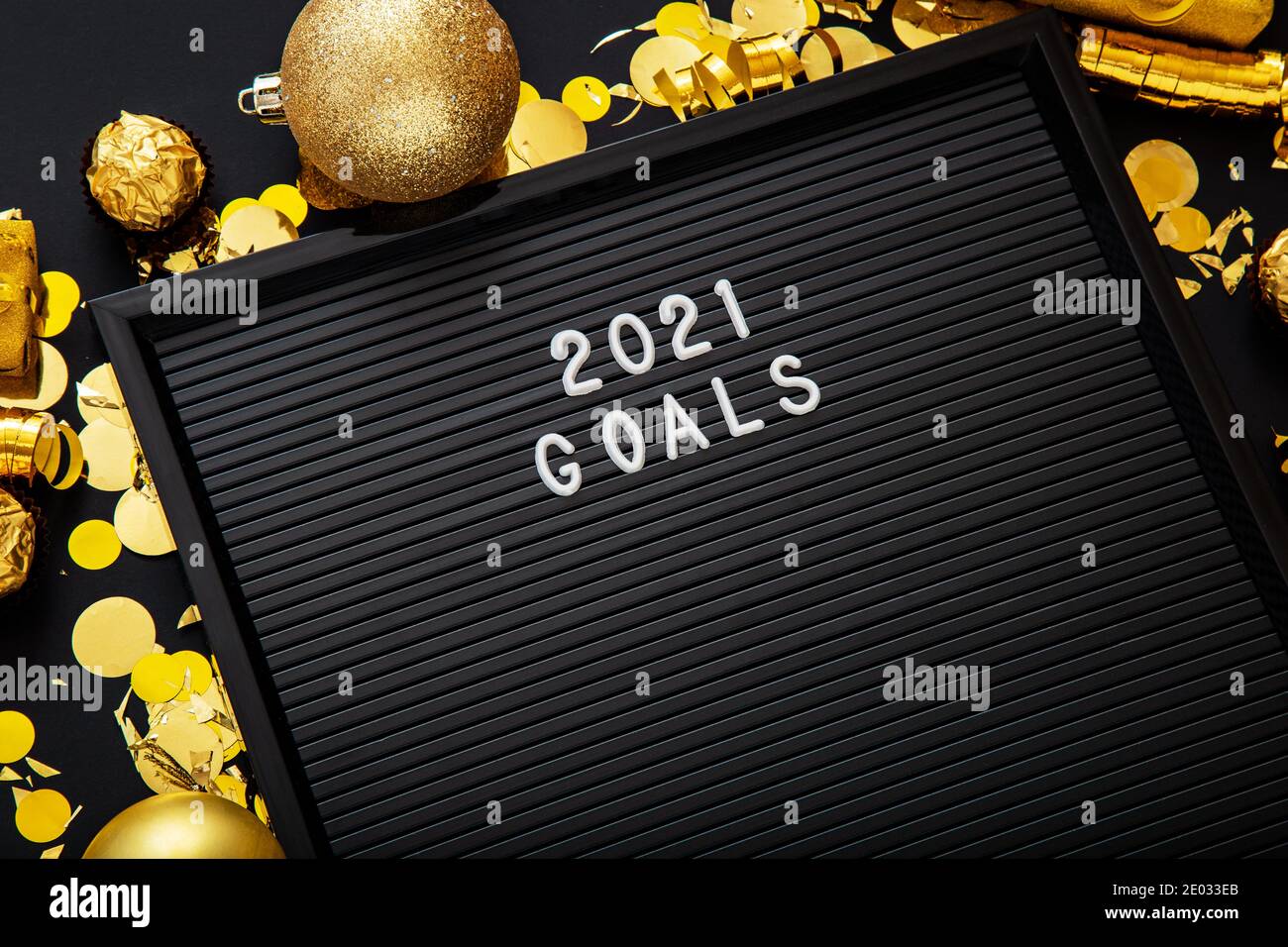 2021 Goals text on black Letter Board in Christmas festive decor, confetti ball. New year 2021 goals Stock Photo