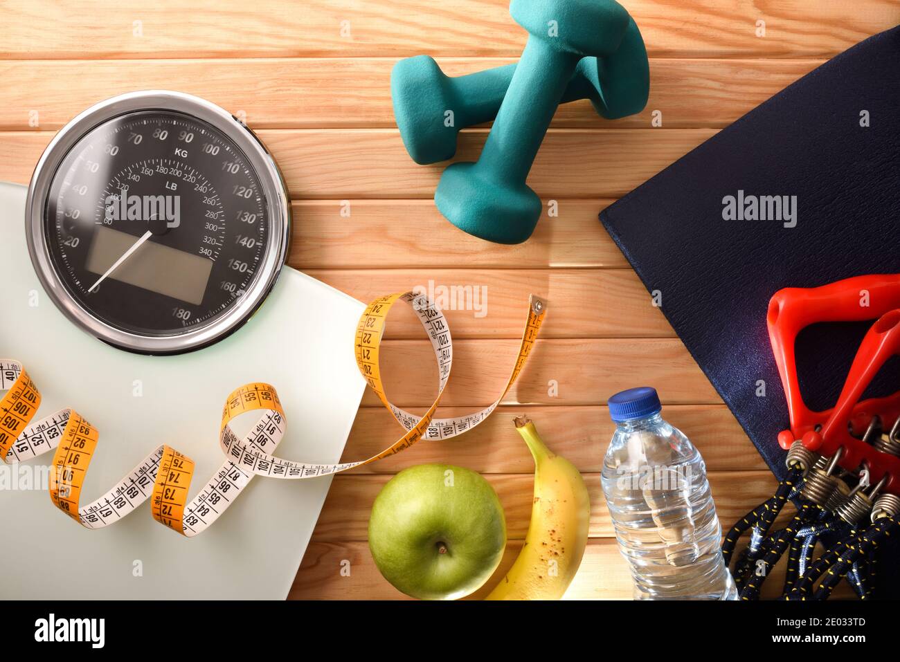 Wellness and health with sports accessories and weight control equipment for healthy life and lose on wood floor. Top view. Horizontal composition. Stock Photo