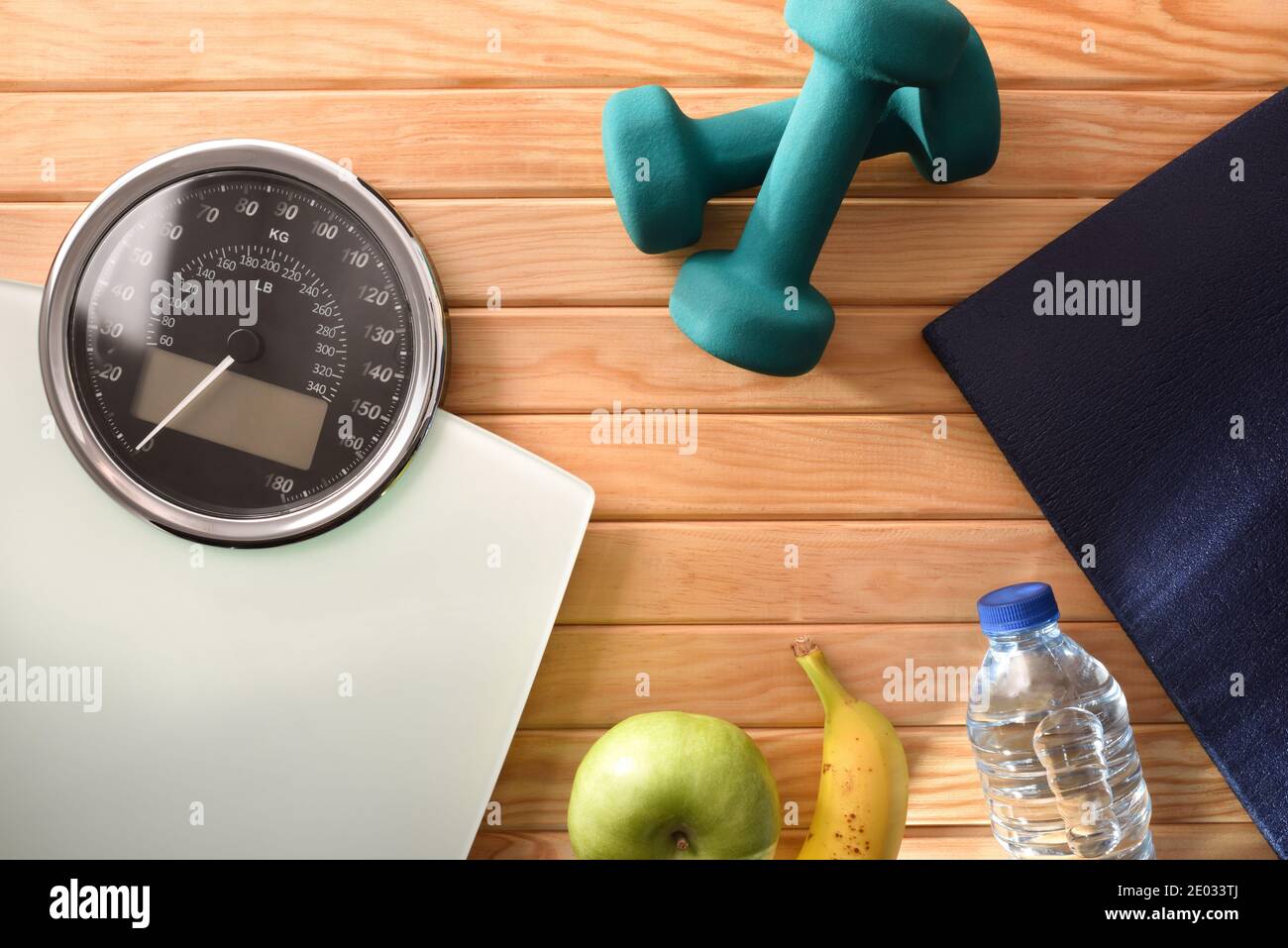 Wellness and health with sports accessories and weight control equipment for healthy life and lose on wood floor. Top view. Horizontal composition. Stock Photo