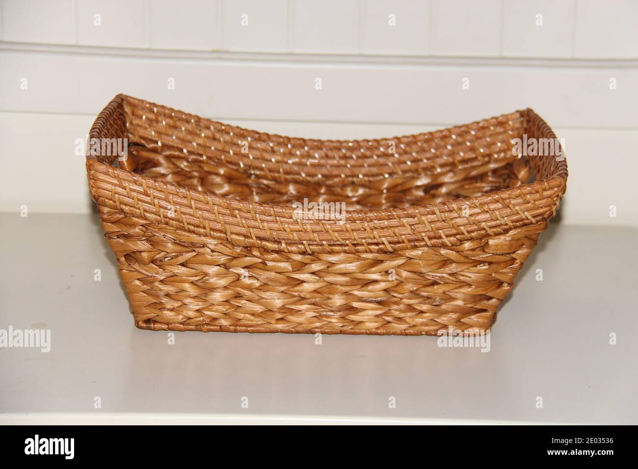 Wicker boat shape basket, isolated on white background. Traditional