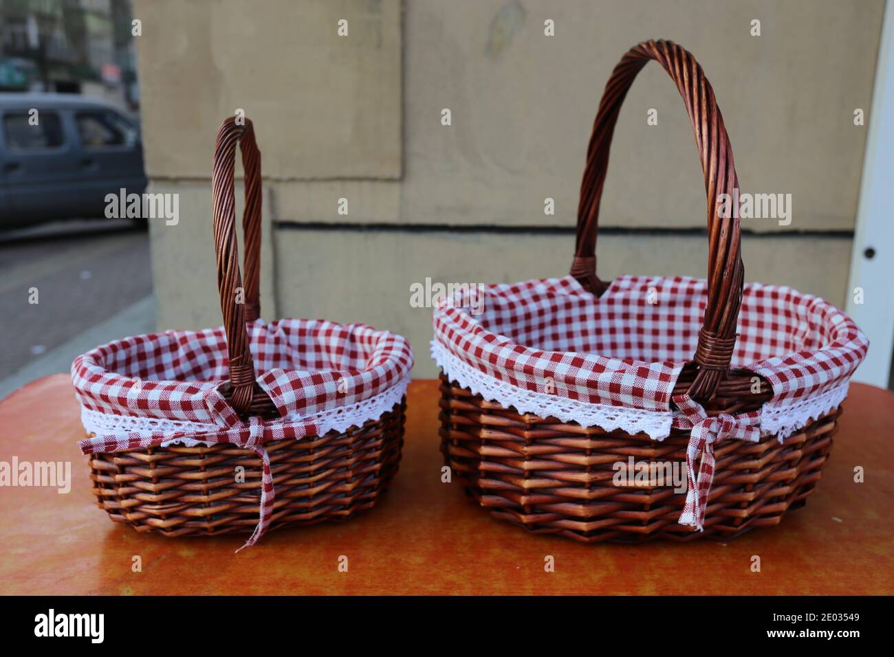 Two brown picnic baskets for sale on the table, food baskets with tablecloth Stock Photo