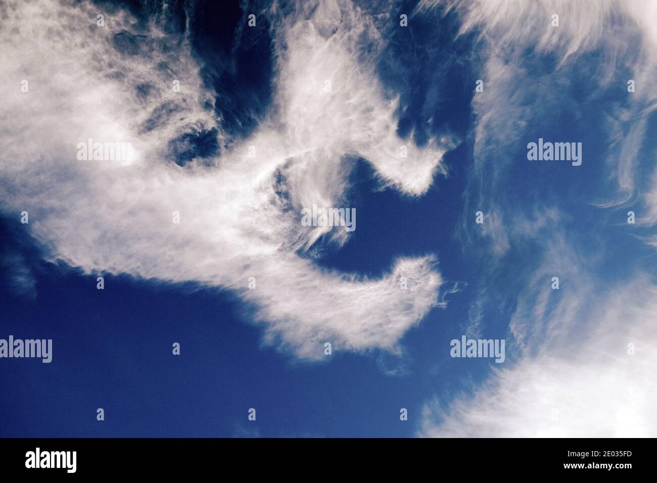 Letter C shape form clouds in blue sky in winter December 2020 Wales UK   KATHY DEWITT Stock Photo
