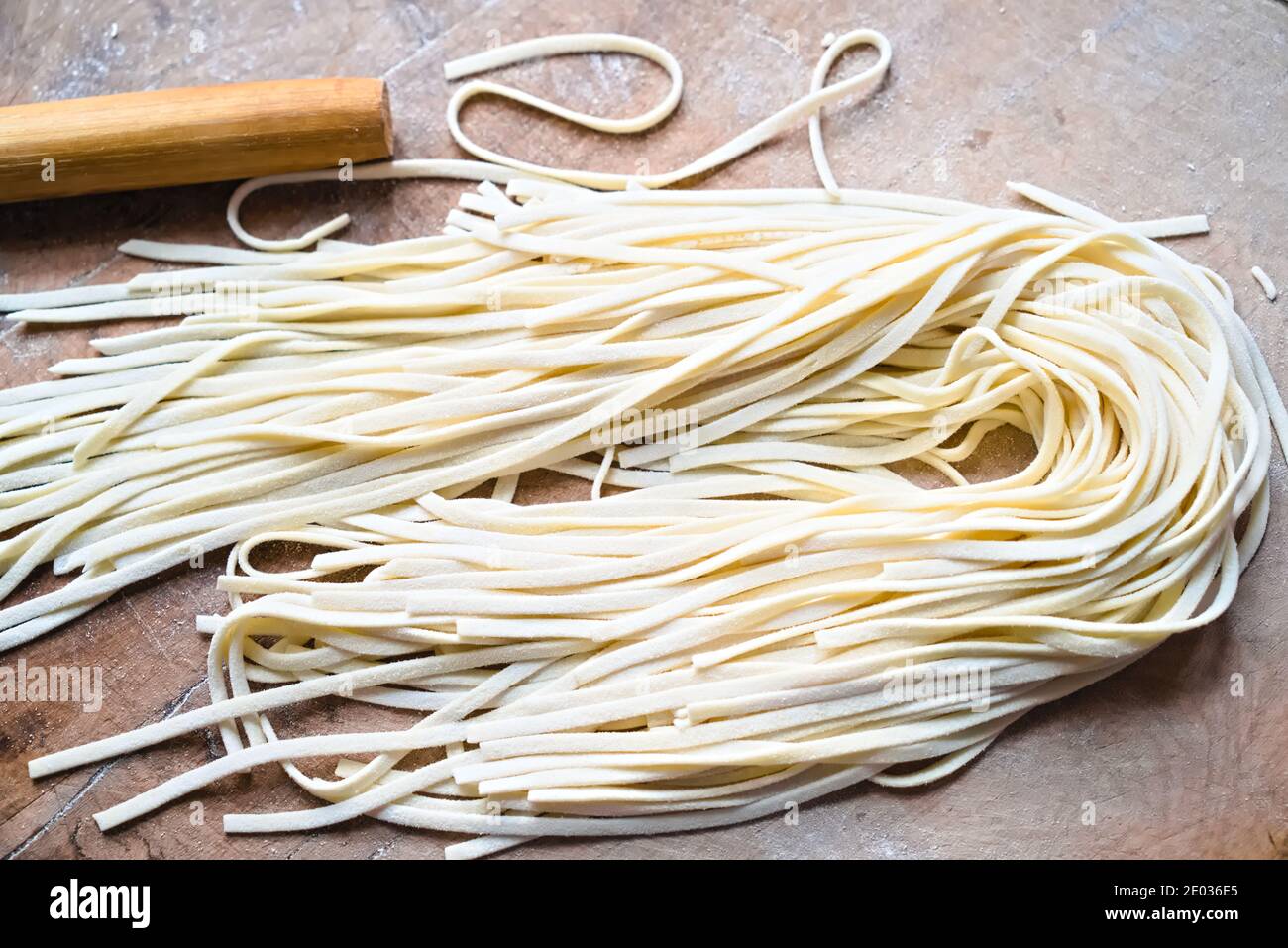 Homemade handrolled noodles, white noodles lying on board, Chinese
