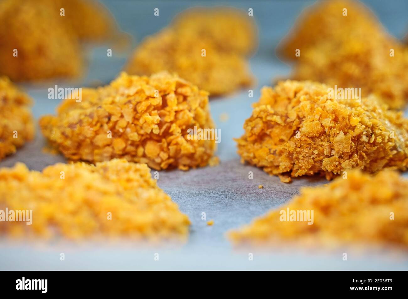 Chicken nuggets on parchment paper before baking Stock Photo Alamy