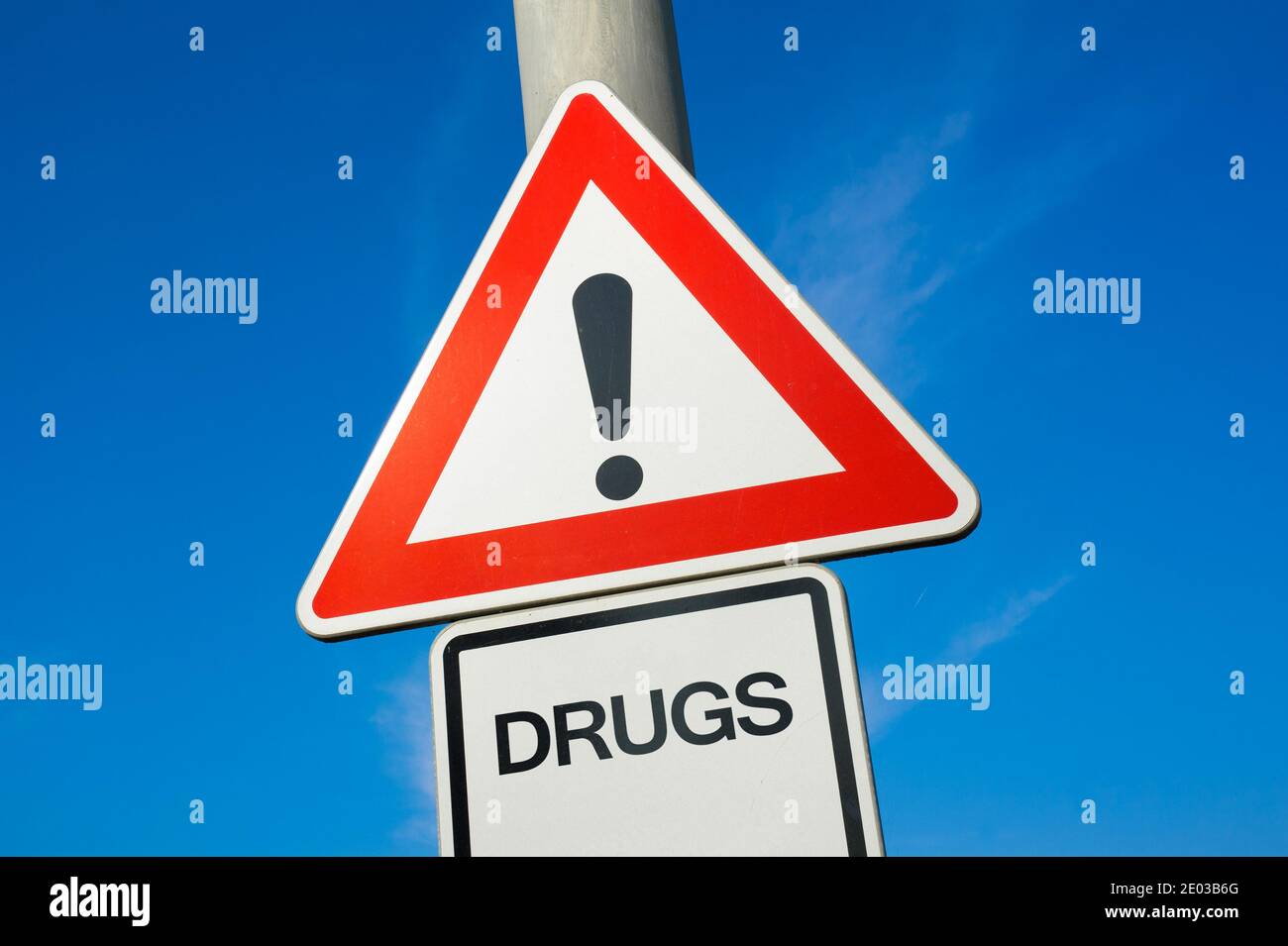 Drugs - traffic sign with exclamation mark to alert, warn caution - substance abuse and misuse leading to addiction and being addict Stock Photo