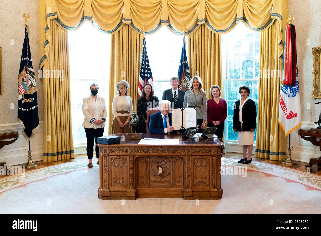 Washington, United States Of America. 17th Dec, 2020. U.S President Donald Trump, joined by First Lady Melania Trump and guests, signs H.R. 473 to Authorize the Every Word We Utter Monument for the District of Columbia in the Oval Office of the White House December 17, 2020 in Washington, DC Credit: Planetpix/Alamy Live News Stock Photo