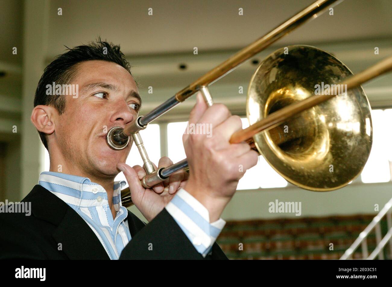 Jockey Frankie Dettori playing trombone at Tattersalls in Newmarket to launch a charity event. Stock Photo