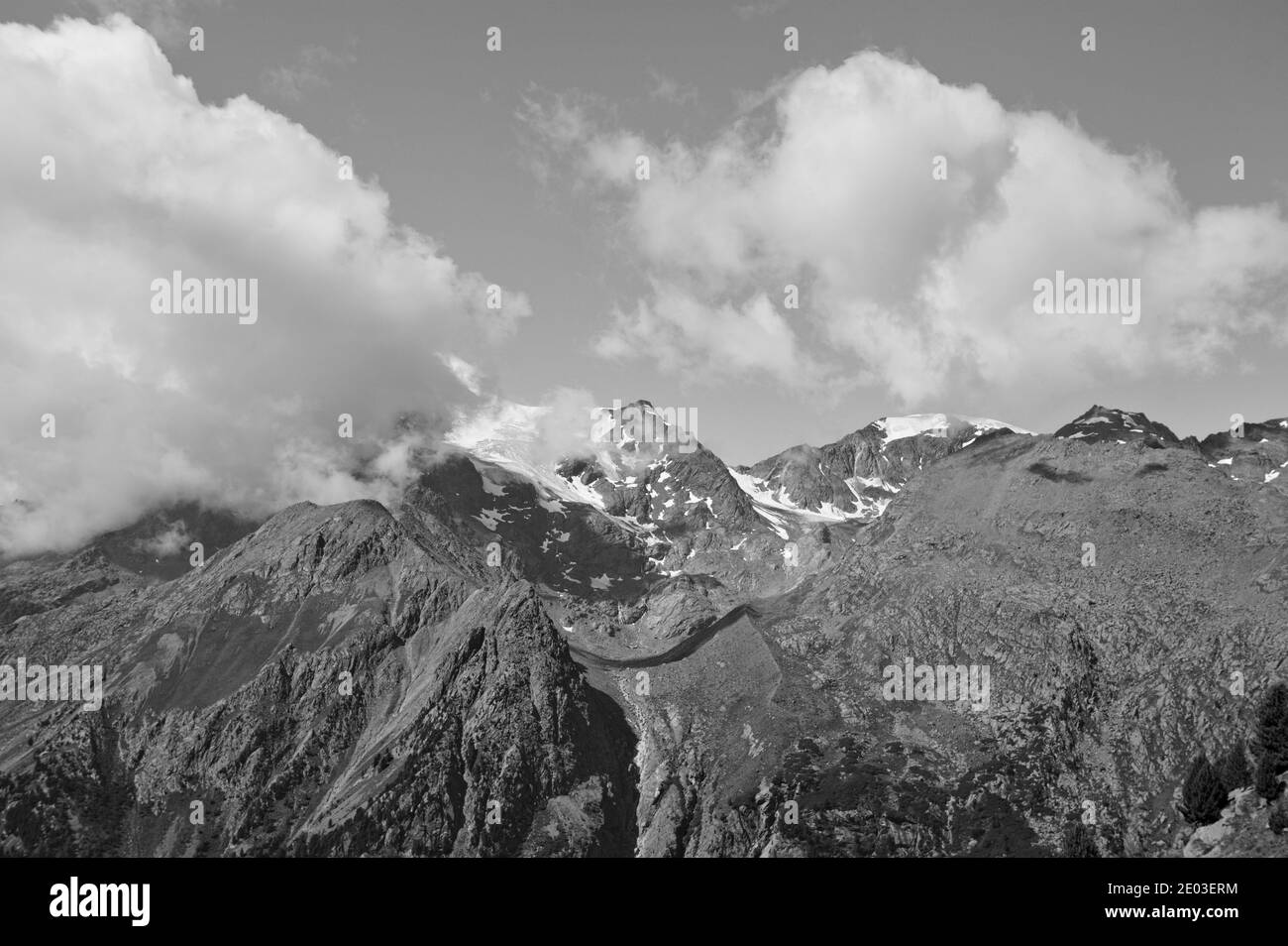 A snowy mountain surrounded by clouds in the Italian Alps (Trentino, Italy, Europe) Stock Photo