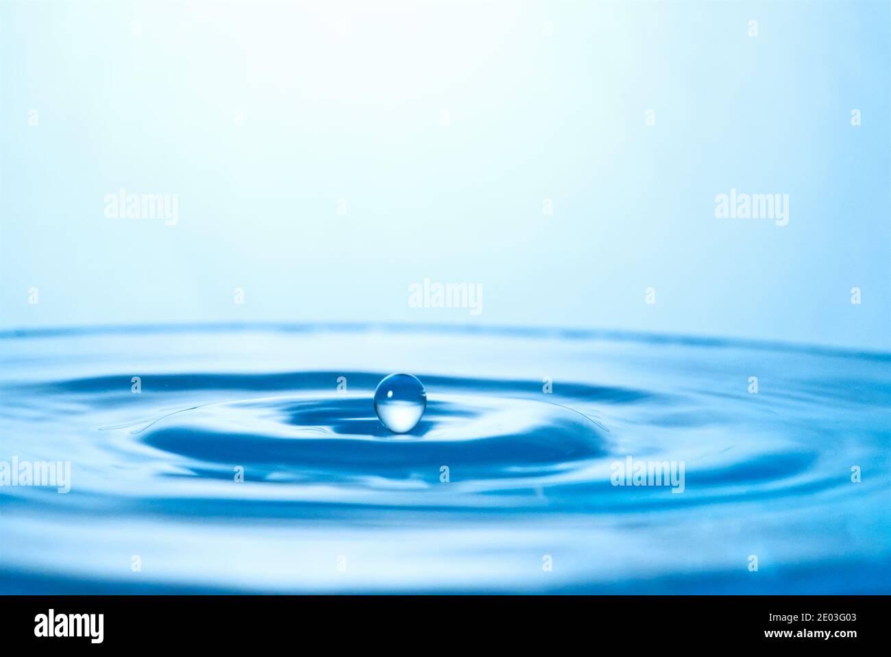 Water splashes and ripples background, freeze motion, falling drop, blue ripple Stock Photo