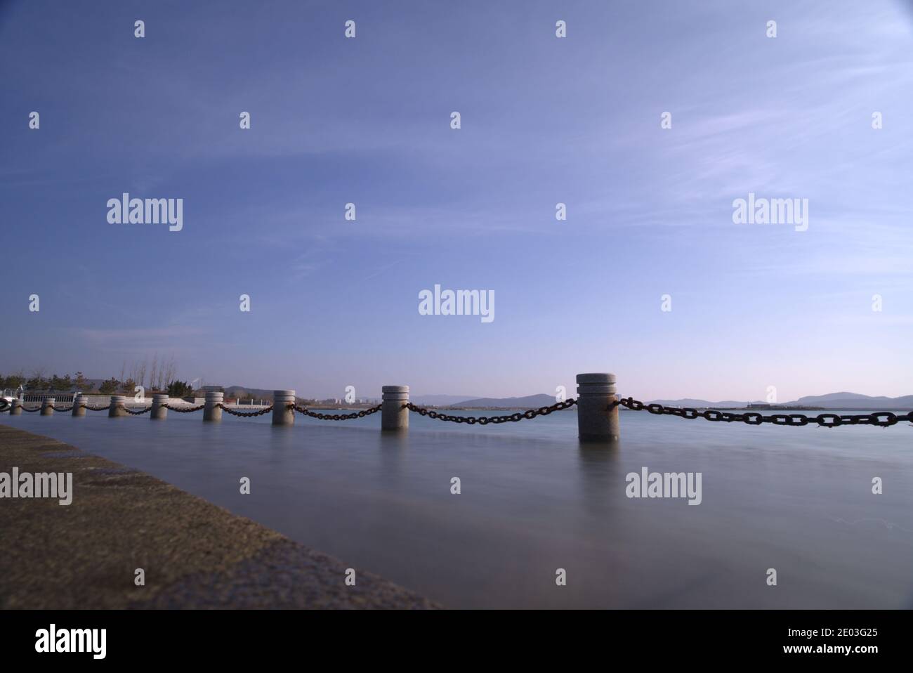 Seaside guardrail, safety protection barrier, harbor in seafront, chain ...