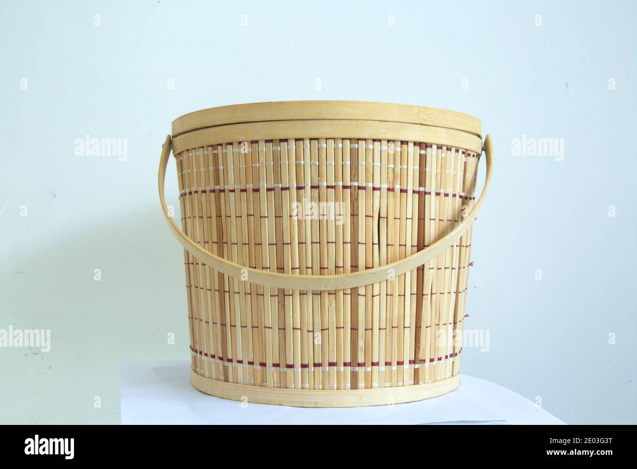Handwoven bamboo basket with handle, traditional handicraft concept