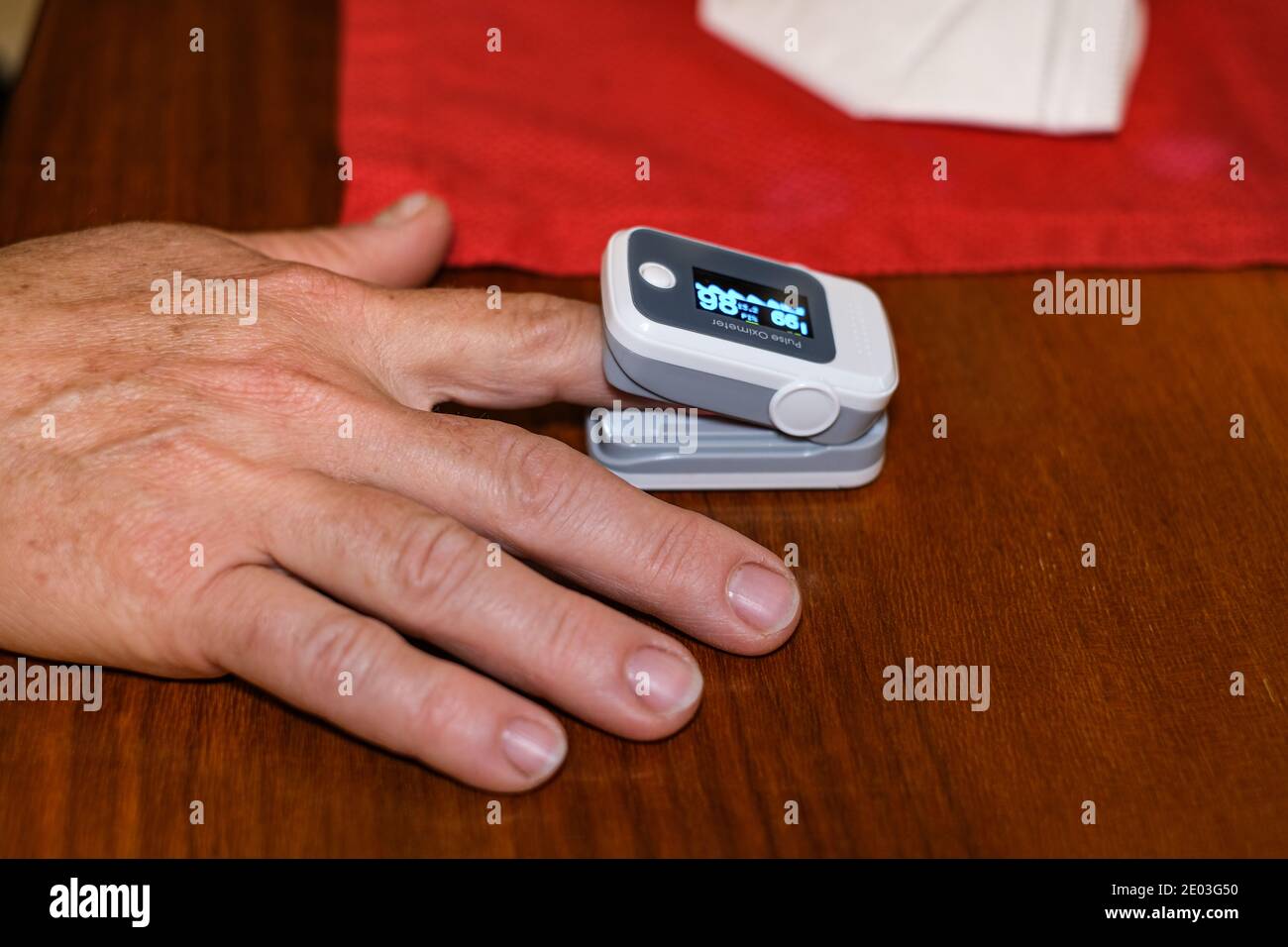 Elderly grandmother Woman using pulse oximeter for oxygen blood saturation measurement,covid19 pandemic disease Stock Photo