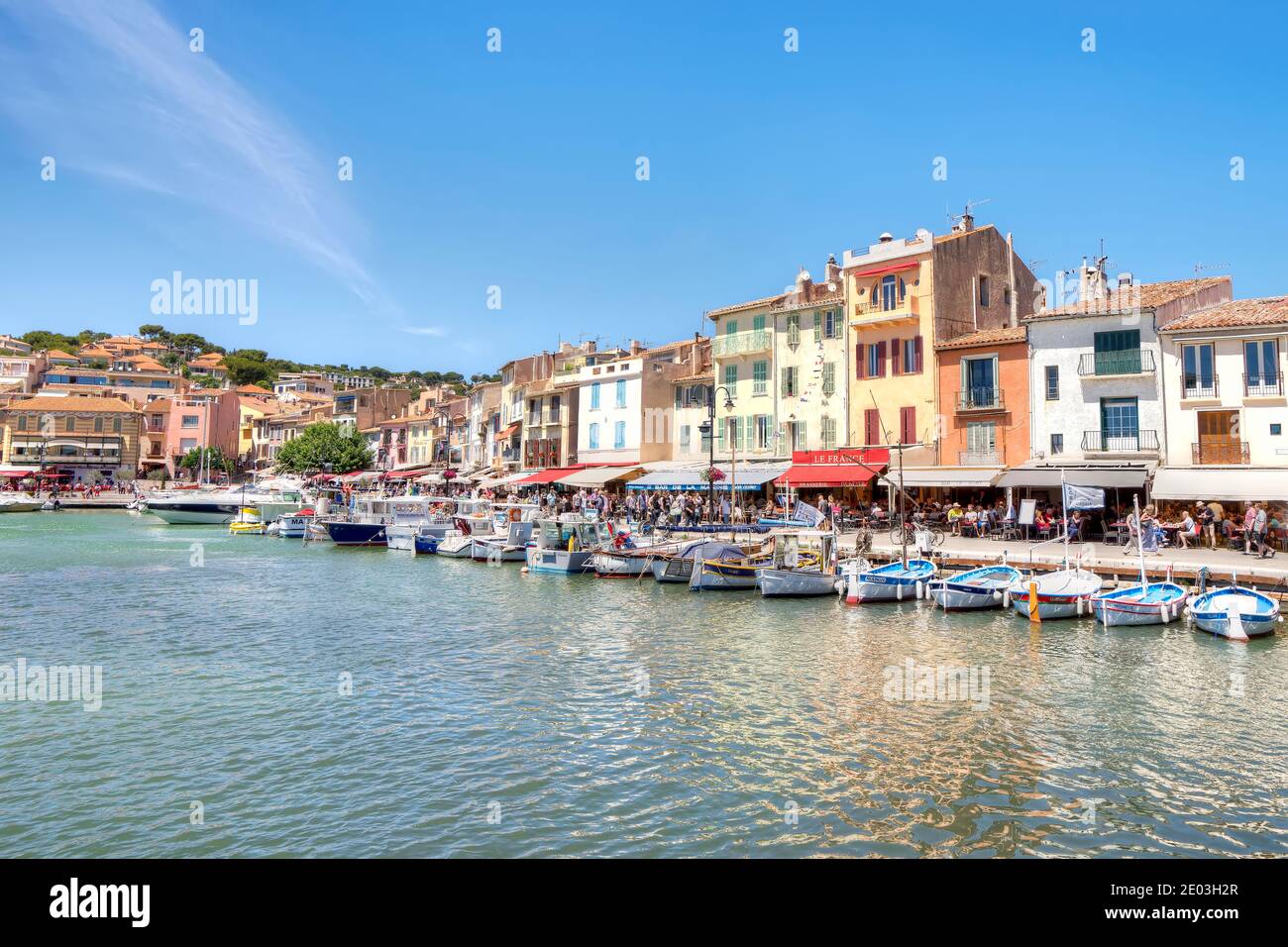 Boats moored in front of the restaurants and stores on the Cassis, Provence, France waterfront Stock Photo