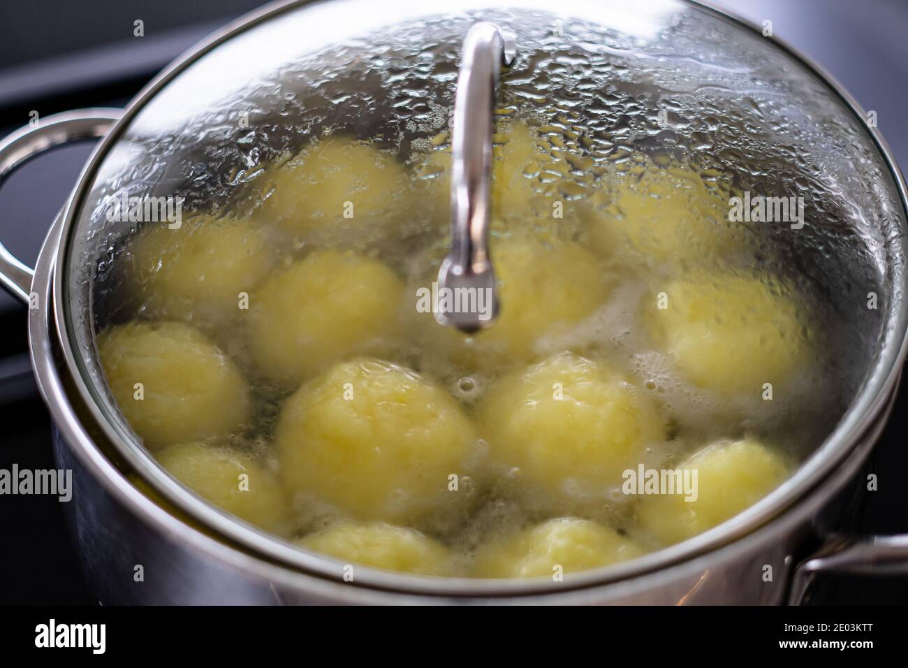 Dumplings simmering in a pot with closed lid Stock Photo