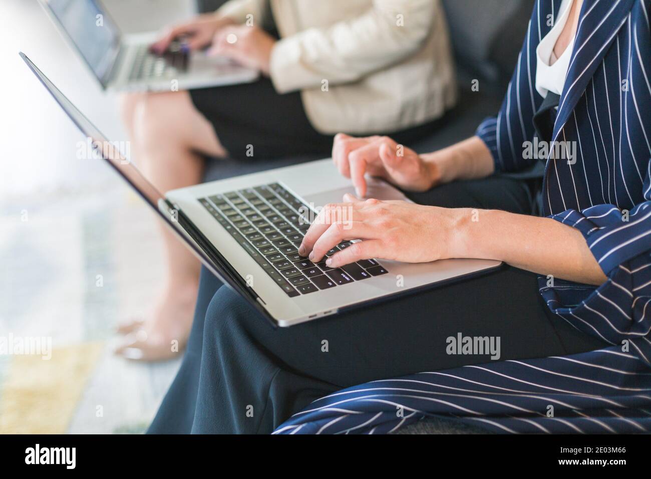 co workers using laptops Stock Photo - Alamy