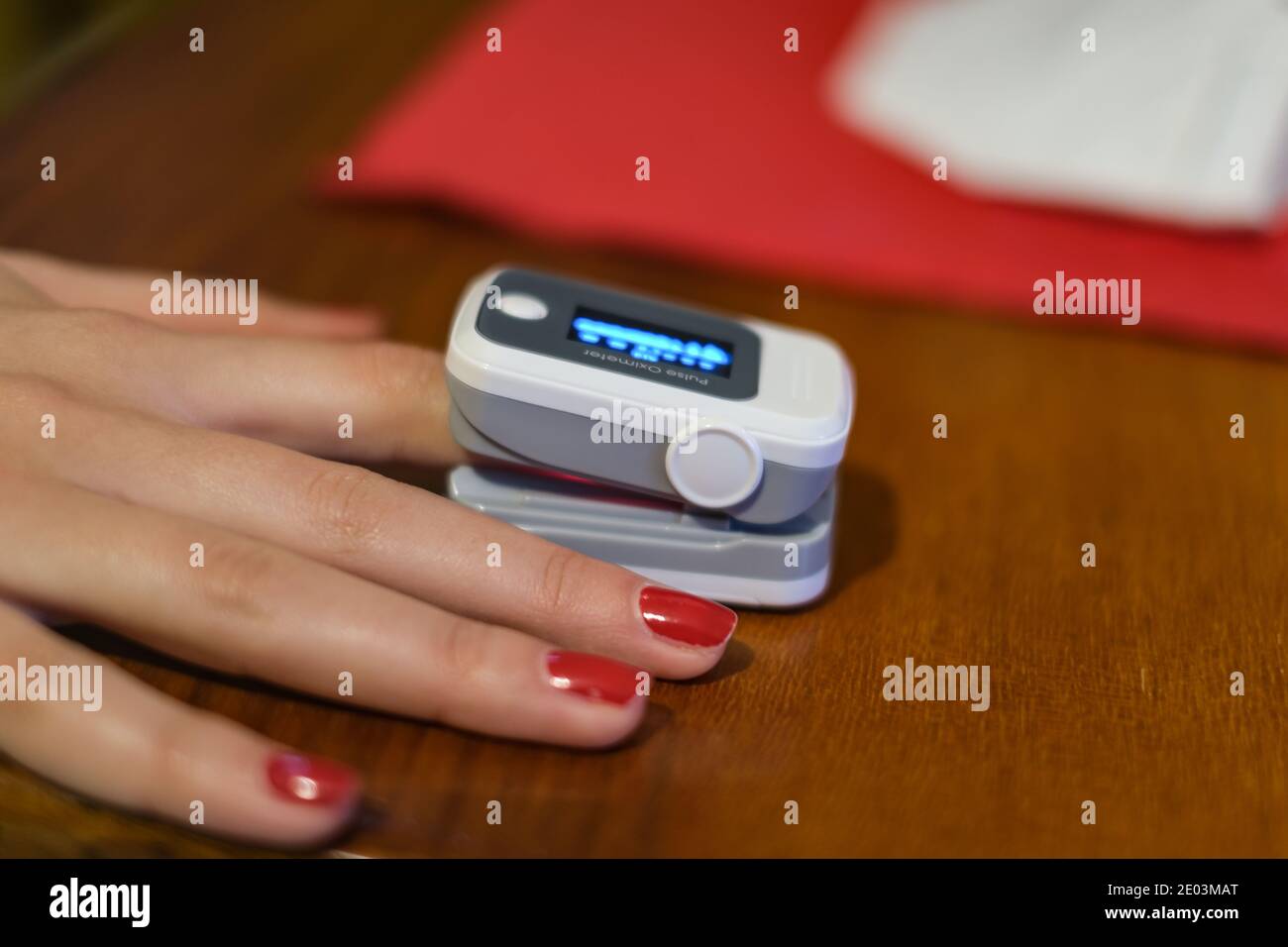 Woman using pulse oximeter for oxygen blood saturation measurement,covid19 pandemic disease Stock Photo