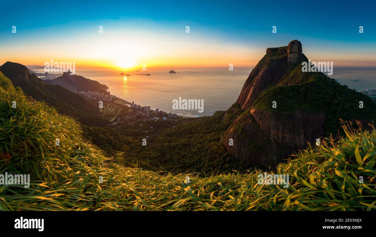 Scenic Panoramic View of Sunrise in Rio de Janeiro City, Pedra da Gavea, Sao Conrado Beach, and Two Brothers Mountain With Favela Rocinha Stock Photo