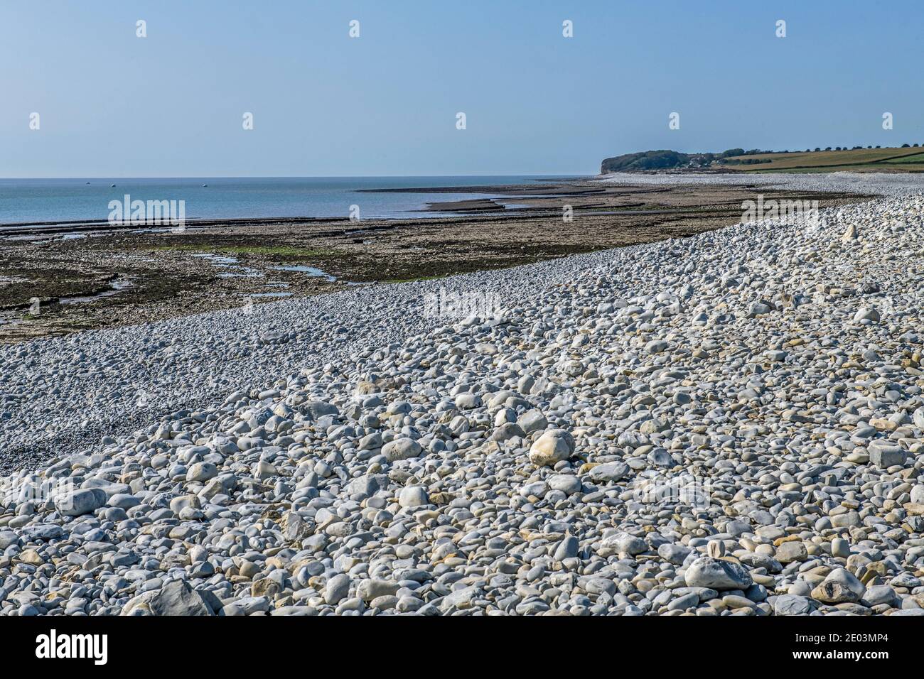 Aberthaw Beach looking west along the coast with pebbles, rocks and sand. This is the start of the Glamorgan Heritage Coast south Wales Stock Photo