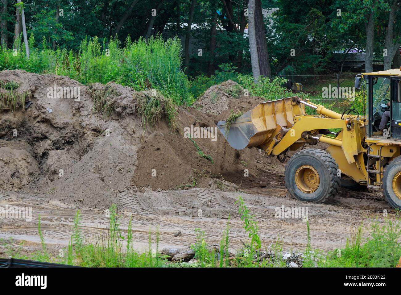 Backhoe digging the ground during works at for soil construction ...