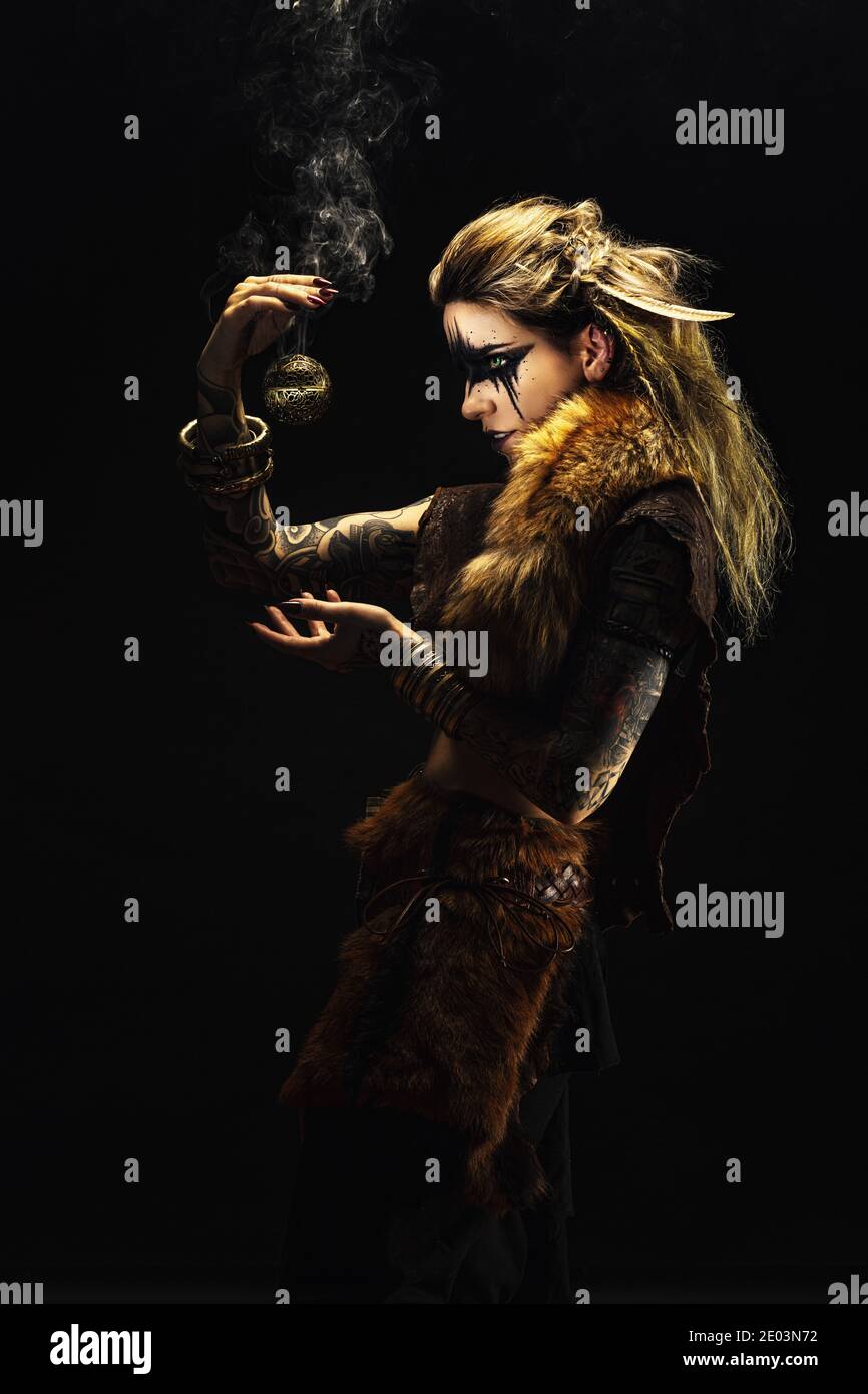 Portrait of a young viking shaman holding a ball of incense in his