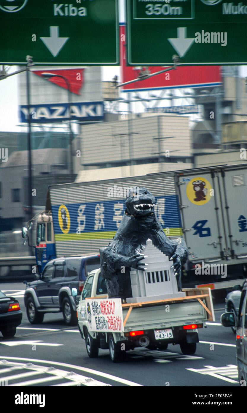 Godzilla in Tokyo. Godzilla riding in the back of a truck. Tokyo, Japan. May 1998 Stock Photo
