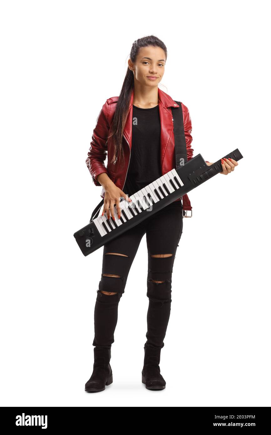 Full length portrait of a female musician playing a keytar and standing isolated on white background Stock Photo