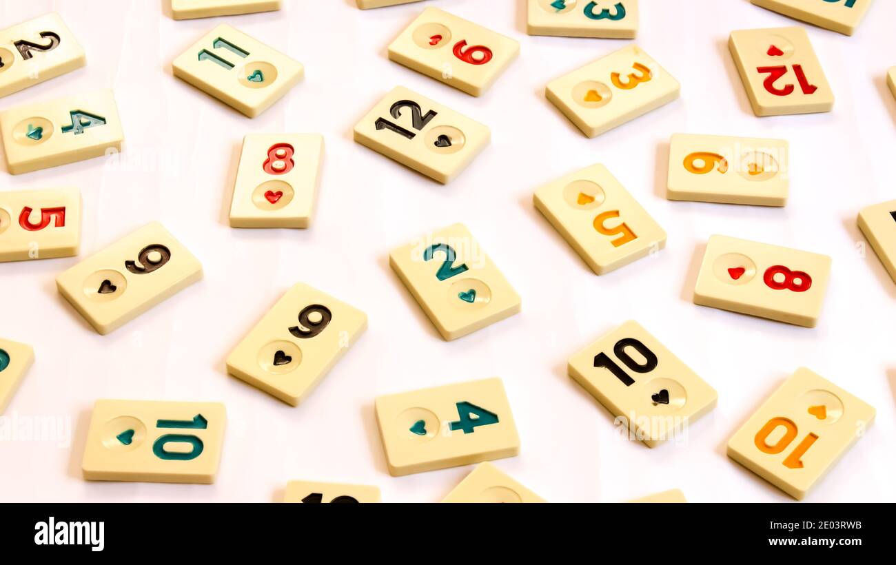 Rummikub tiles on white background. Colorful wallpaper. A board game