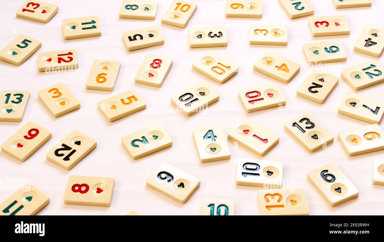 Rummikub tiles on white background. Colorful wallpaper. A board game