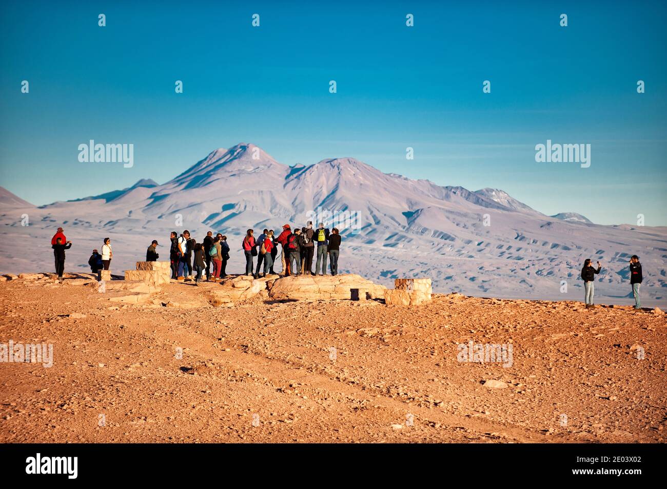 Tourist people standing on a rock overlooking Aatacama Deser. San Pedro de Atacama, Chile Stock Photo