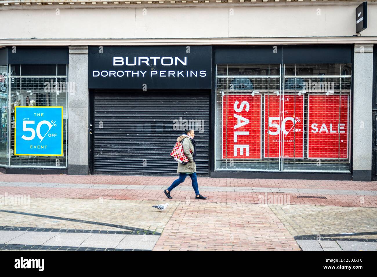 Closed Arcadia Group Burton, Dorothy Perkins shop in High Street, in  Southend on Sea, Essex, UK. Shopper passing by. Half price sale posters  Stock Photo - Alamy