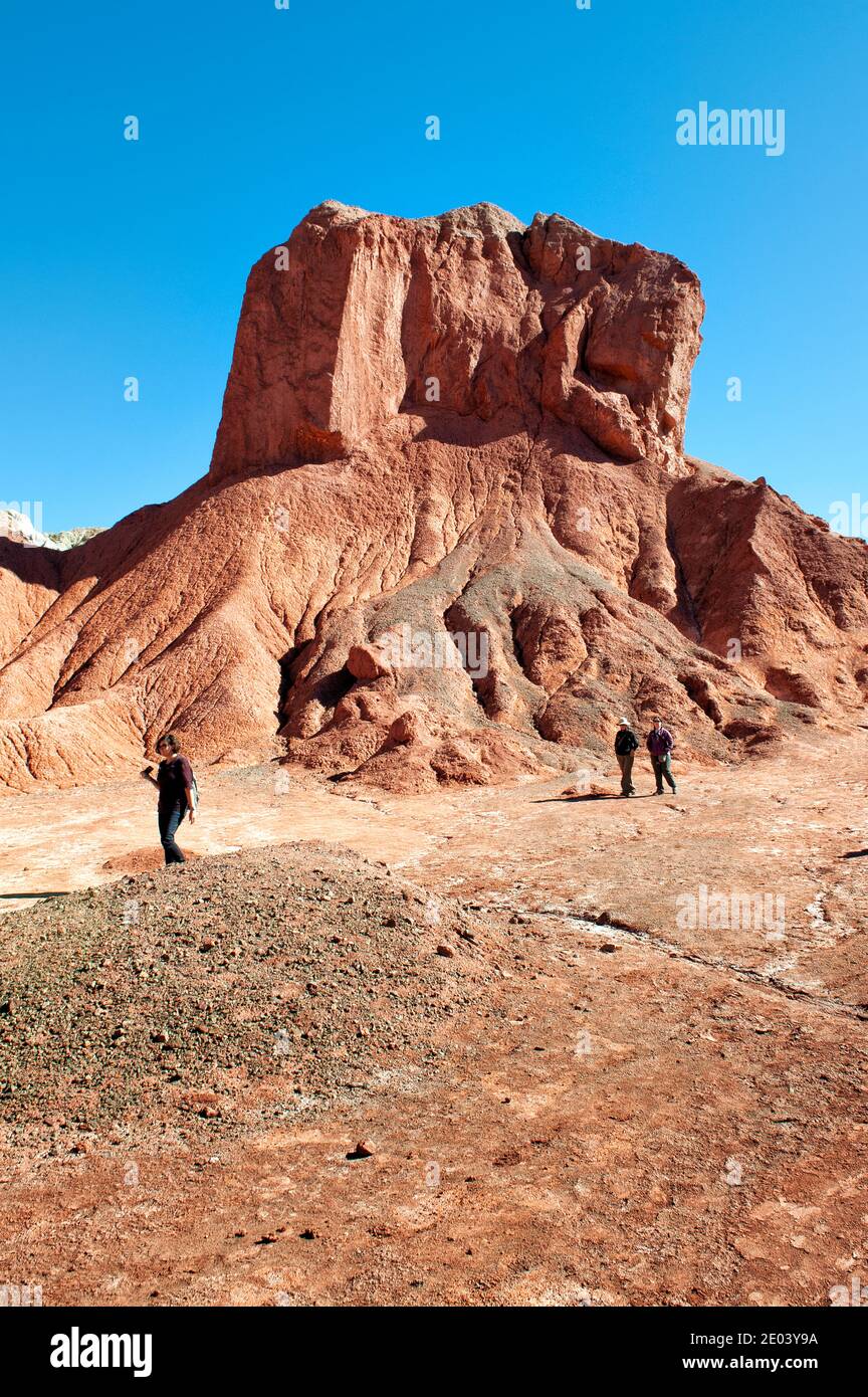People walking next a big rock in Atacama Desert Stock Photo - Alamy