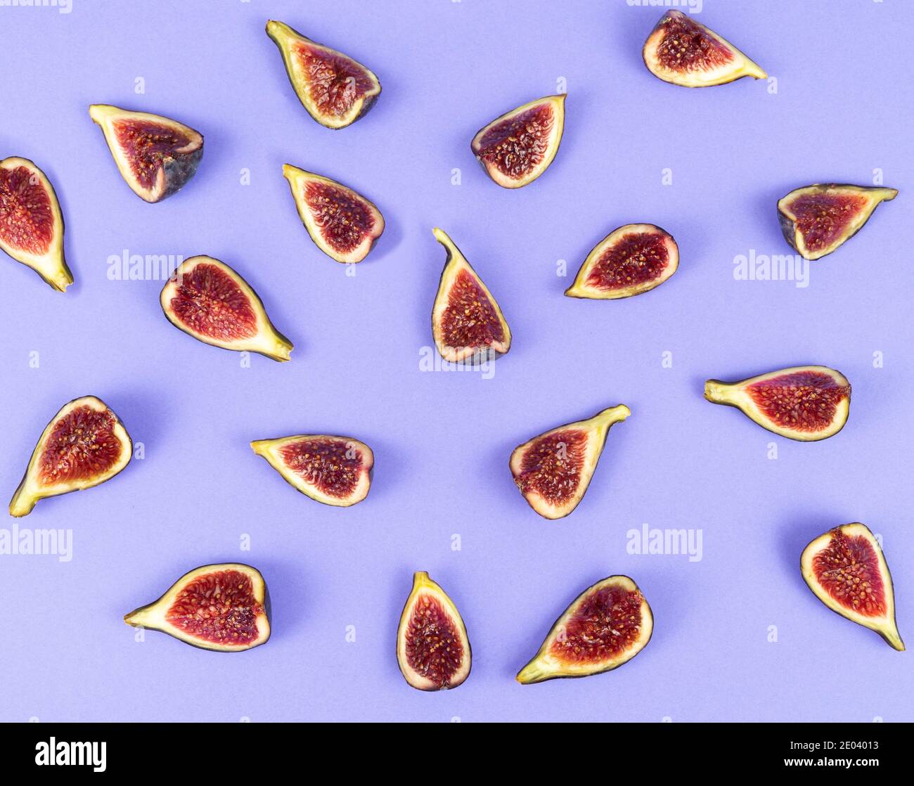 Cut figs on a blue background. Copy space. Flat lay. Top view. Stock Photo