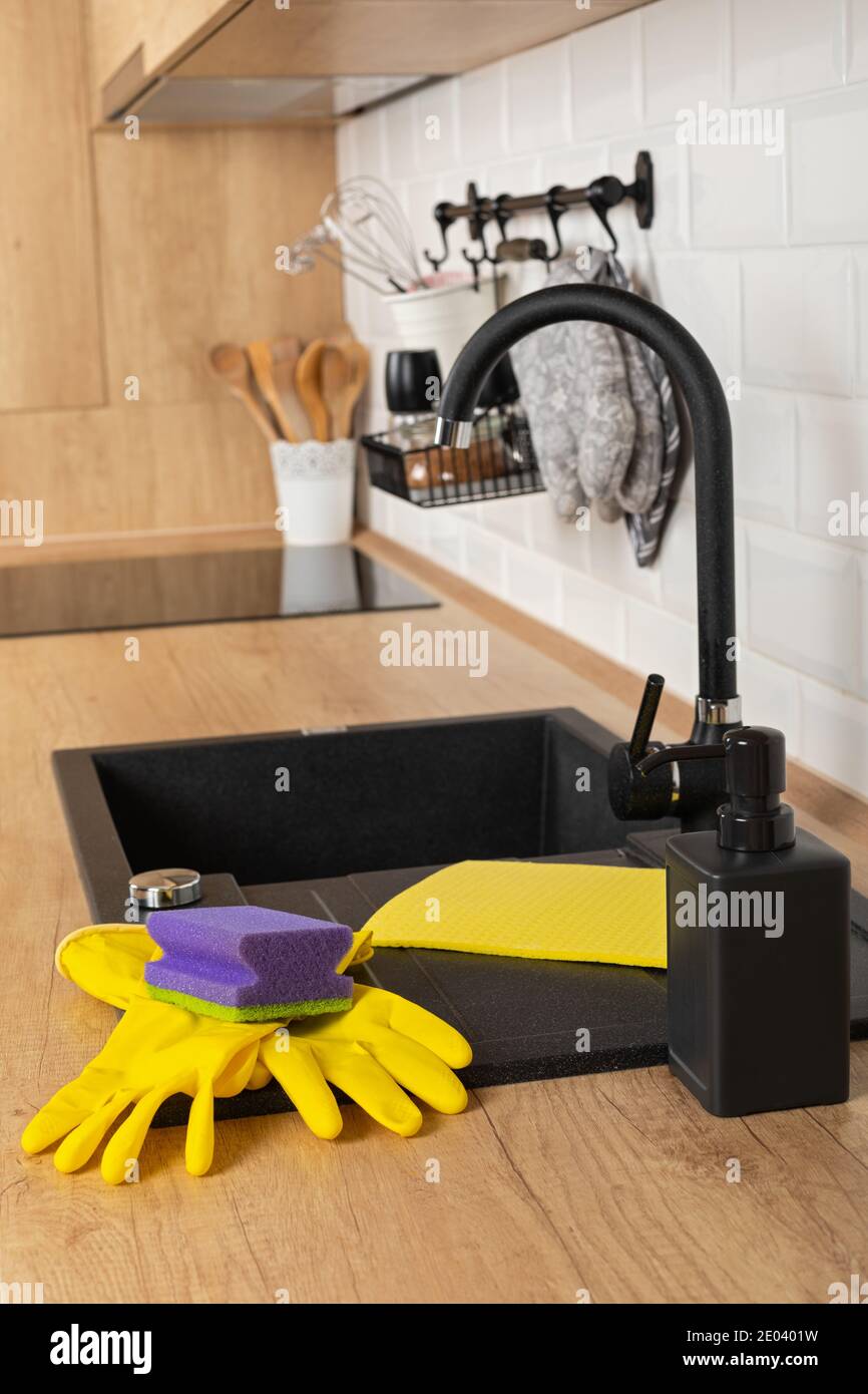 Close up picture of a clean wooden kitchen countertop and black sink ...